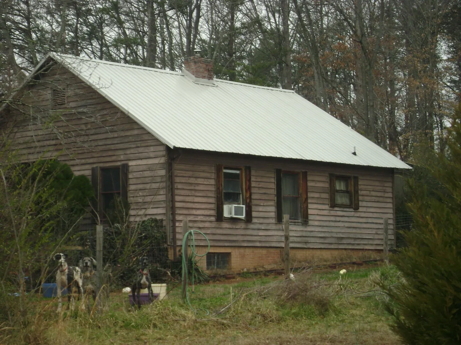 White metal roof on an old wood sided farmhouse, from a Asphalt Shingle Roof Repair job in Remlap